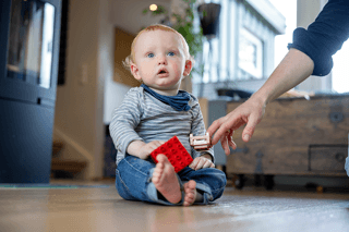 Child sitting on the floor.